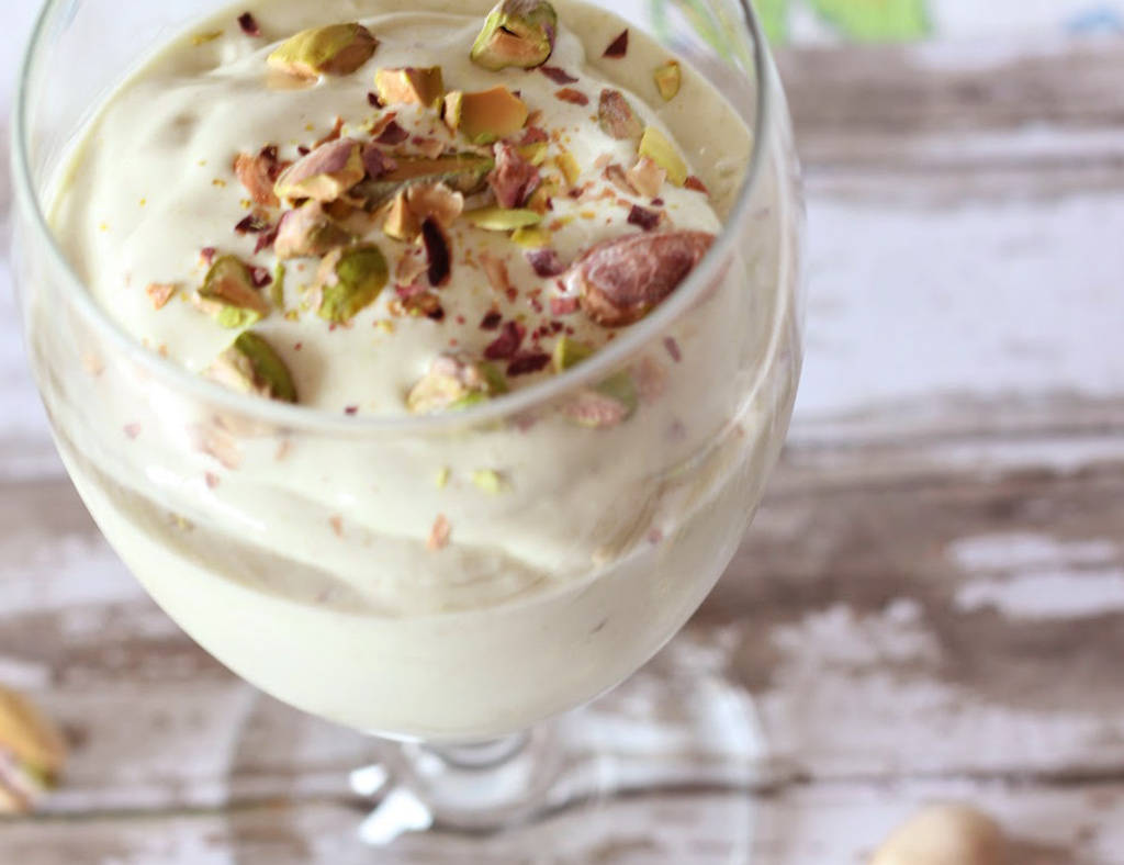 Non-Alcohol Pistachio-Maple Shake in a big glass, garnished with chopped pistachio nuts.