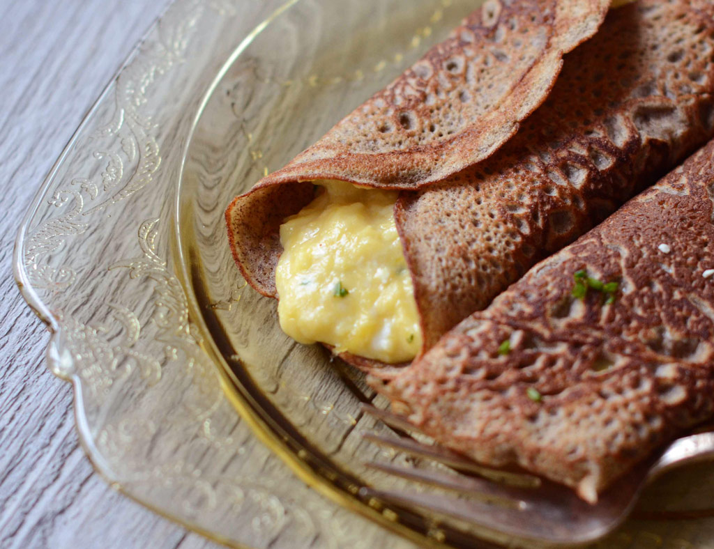 Two Maple Buckwheat Crêpes with cheese on the plate.