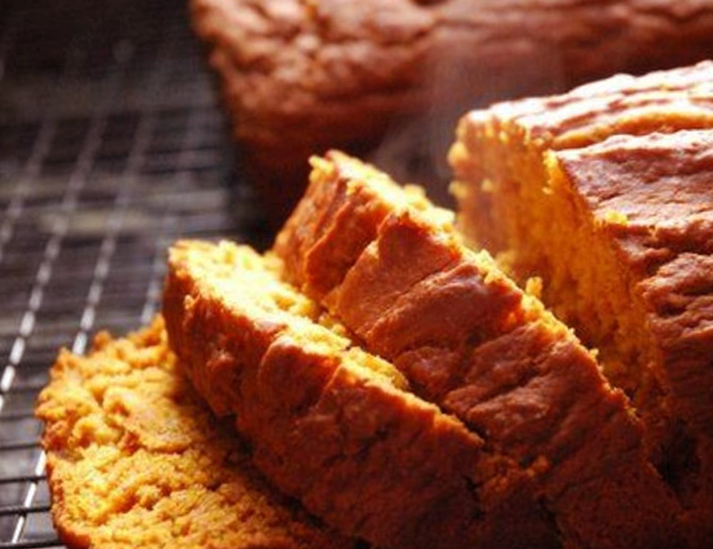 Hot sliced Pumpkin Loaf on a wire rank.