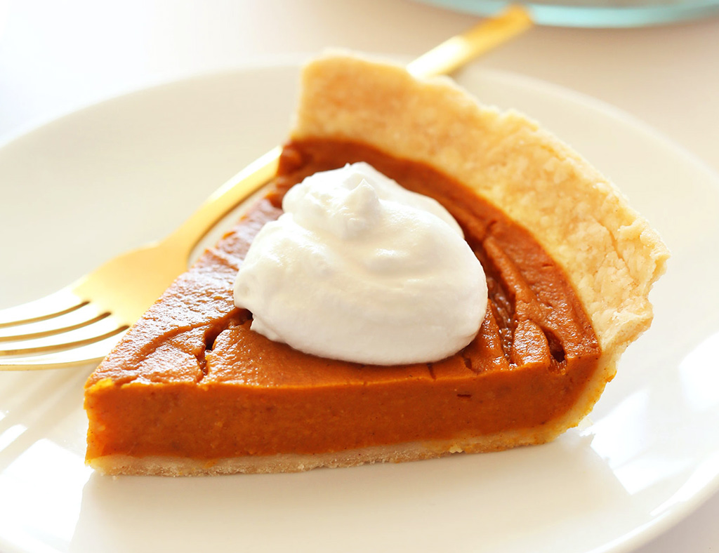 A beautiful piece of Sweet Potato Pie with Ice Cream on the plate.